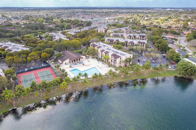 an aerial view of residential houses with outdoor space and swimming pool