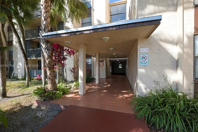a view of a street with potted plants