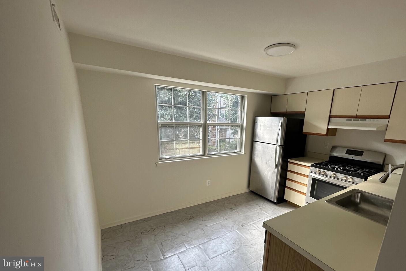 1002 Valley Glen Road, Unit 239 Elkins Park, PA 19027 - Photo 6 of 23 a kitchen with stainless steel appliances a refrigerator and a stove top oven