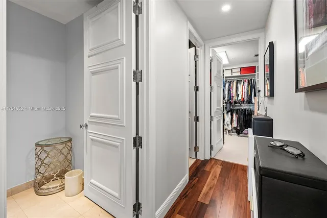 a view of walk in closet with clothes and shoes