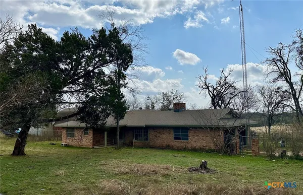 a house that has a tree in front of it