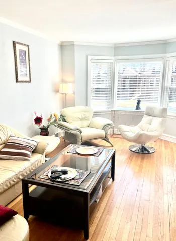 a living room with granite countertop kitchen furniture and floor to ceiling windows