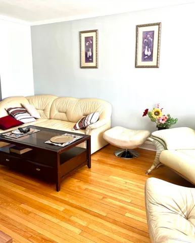 a living room with furniture and a mirror