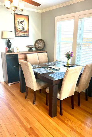 a dining room with furniture and wooden floor