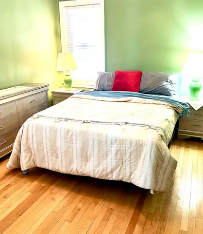 a bedroom with a bed and window