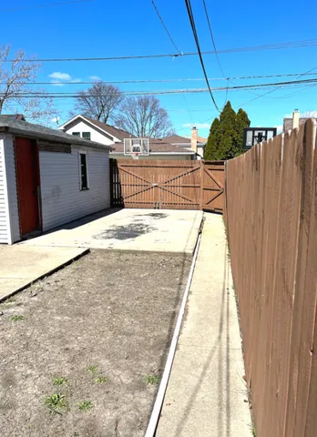 a view of a balcony with wooden floor and fence