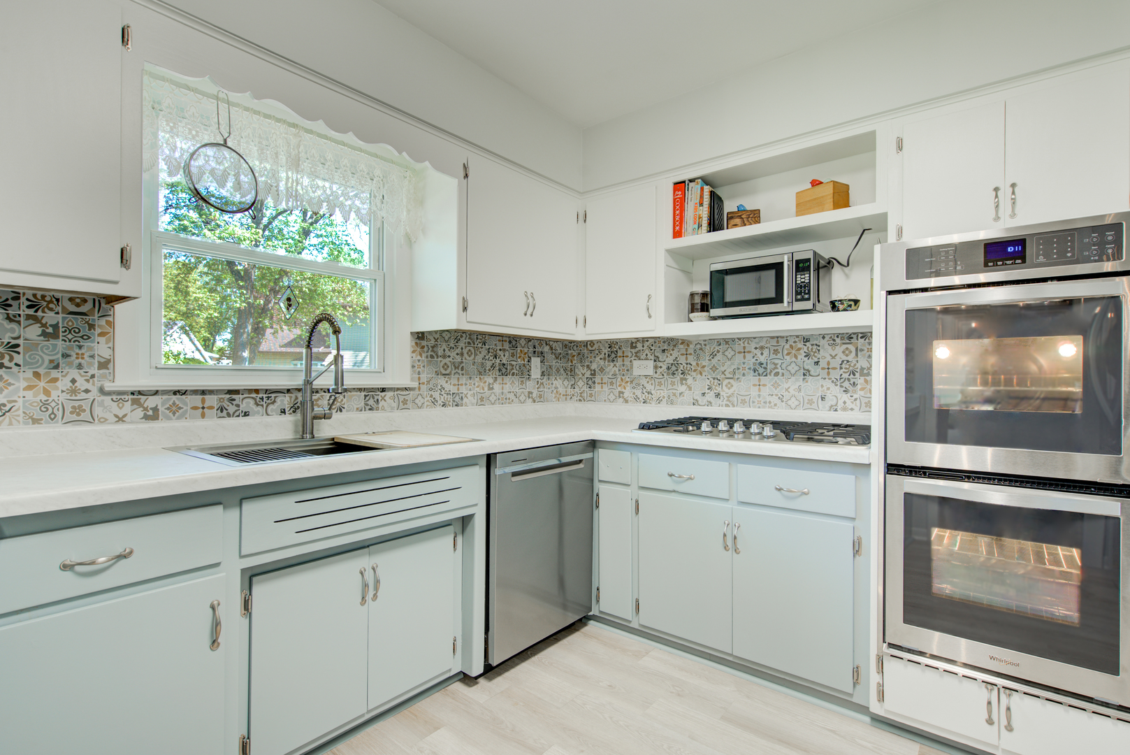 272 Scott Street Wheeling, IL 60090 - Photo 5 of 28 a kitchen with stainless steel appliances granite countertop a stove a sink and a microwave
