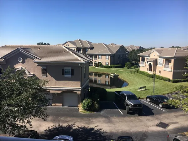 an aerial view of a house with garden space and street view