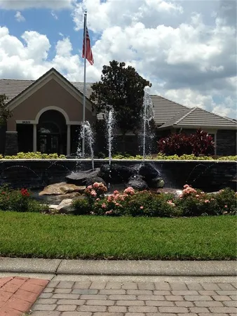 a front view of a house with a yard and trees
