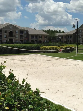 a view of residential houses with yard and ocean view