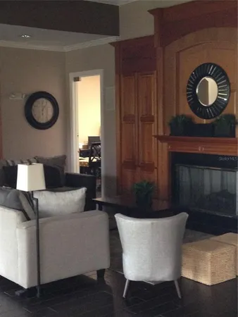 a living room with furniture a rug and a large window
