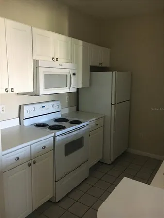 a kitchen with stainless steel appliances a stove a microwave and a refrigerator