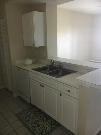 a kitchen with a sink and cabinets