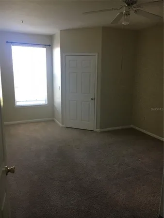 an empty room that has a window in it