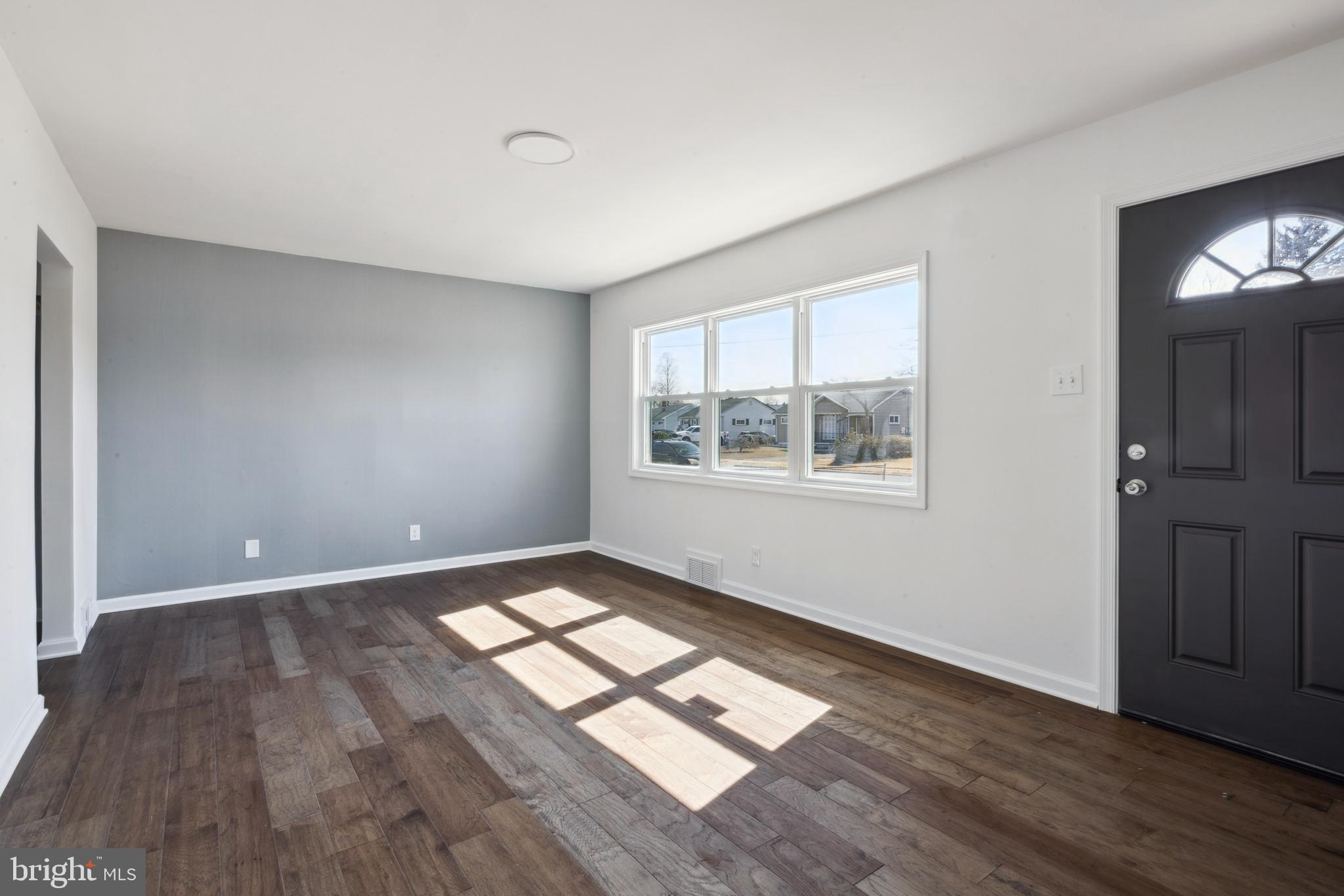 324 Baldwin Road Glassboro, NJ 08028 - Photo 4 of 14 a view of empty room with wooden floor and fan
