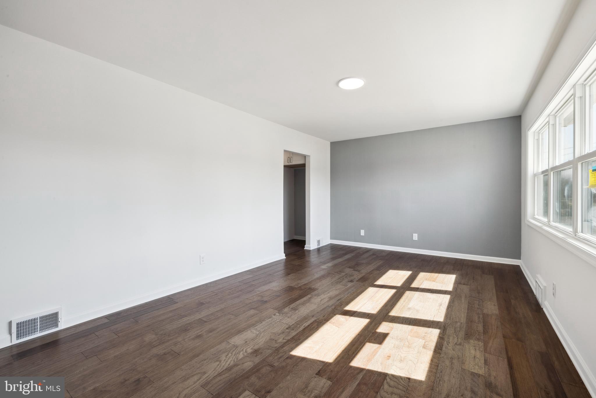 324 Baldwin Road Glassboro, NJ 08028 - Photo 5 of 14 an empty room with wooden floor and windows