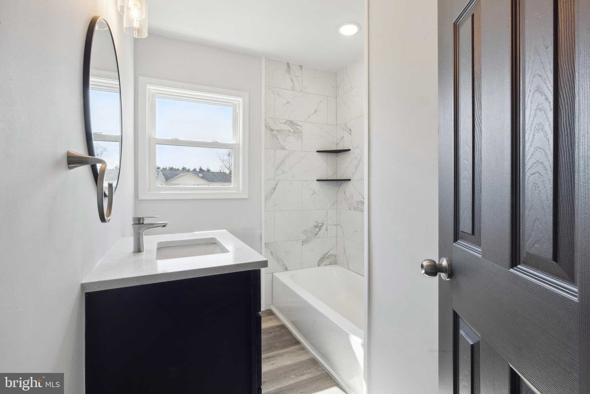 324 Baldwin Road Glassboro, NJ 08028 - Photo 8 of 14 a bathroom with a sink and a mirror
