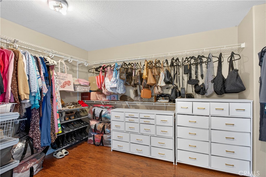 31928 Cercle Chambertin Temecula, CA 92591 - Photo 41 of 74 a view of walk in closet with clothes and shoes