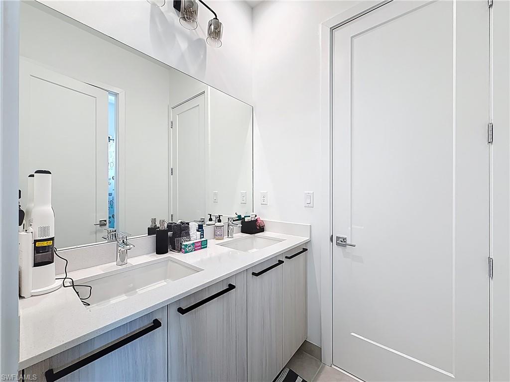 5277 Lamone Ln Avenue Immokalee, FL 34142 - Photo 11 of 27 a bathroom with a sink and a mirror