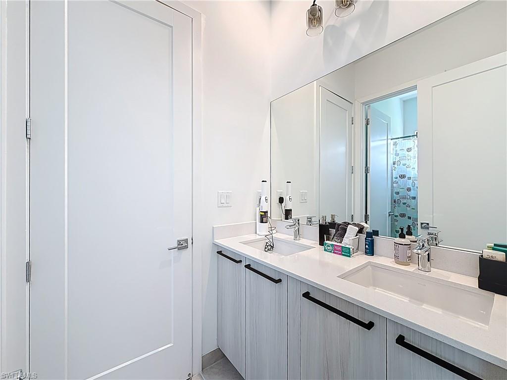5277 Lamone Ln Avenue Immokalee, FL 34142 - Photo 13 of 27 a bathroom with a sink and a mirror