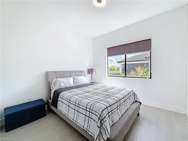 a bedroom with a bed and a computer on the desk