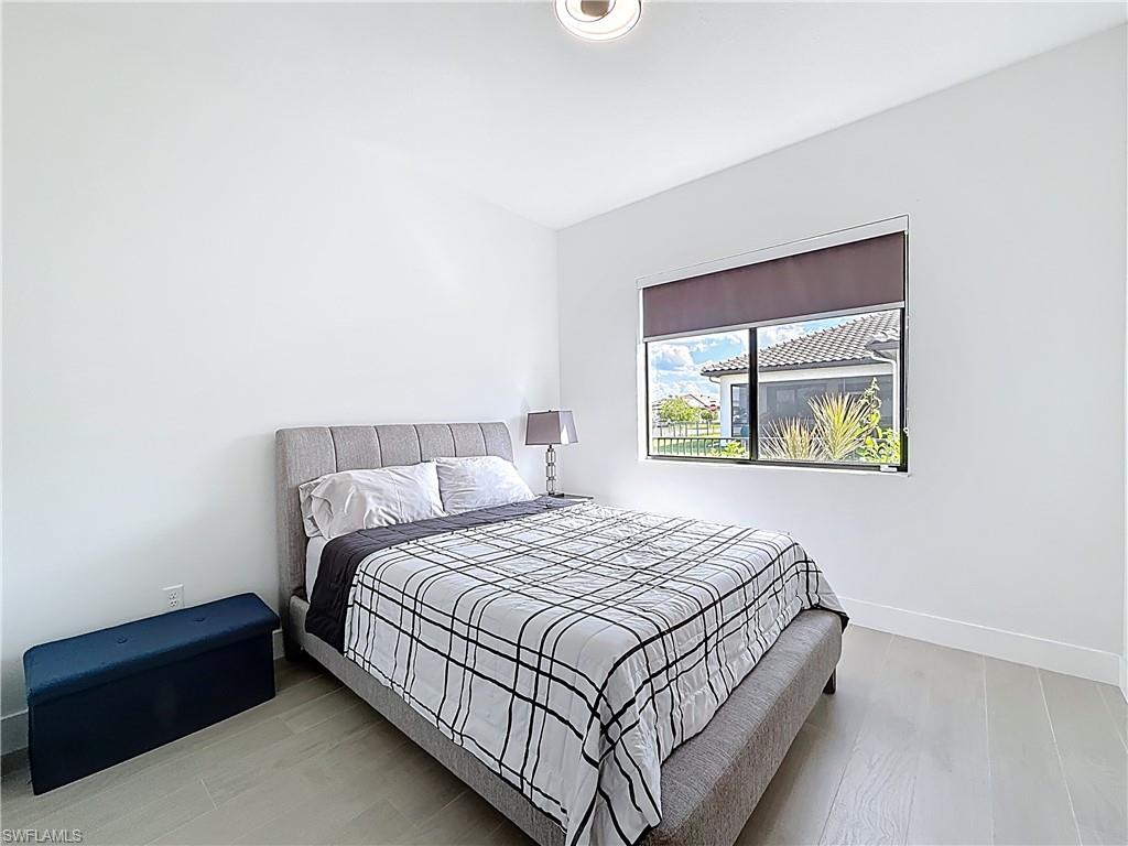 5277 Lamone Ln Avenue Immokalee, FL 34142 - Photo 14 of 27 a bedroom with a bed and window