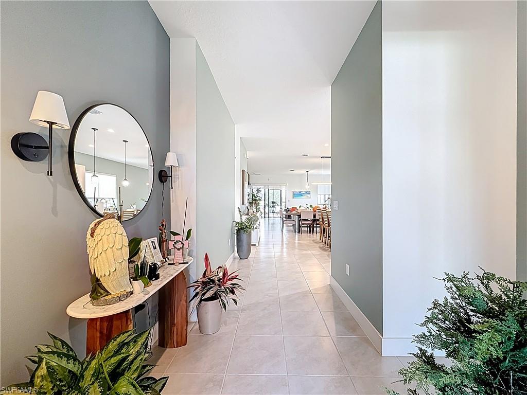 5277 Lamone Ln Avenue Immokalee, FL 34142 - Photo 2 of 27 an entryway with wooden floor table and chairs