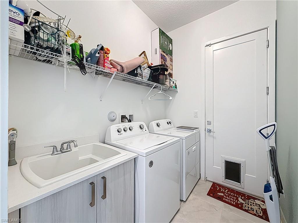 5277 Lamone Ln Avenue Immokalee, FL 34142 - Photo 21 of 27 a utility room with dryer and washer