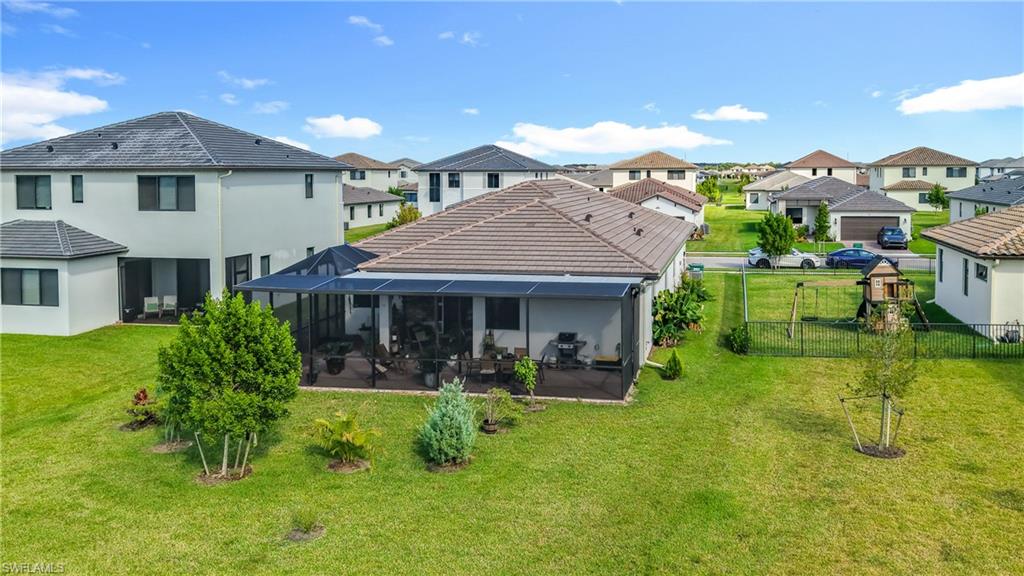 5277 Lamone Ln Avenue Immokalee, FL 34142 - Photo 26 of 27 a view of a house with a backyard and sitting area