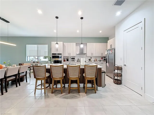 a kitchen with stainless steel appliances granite countertop a refrigerator sink and cabinets