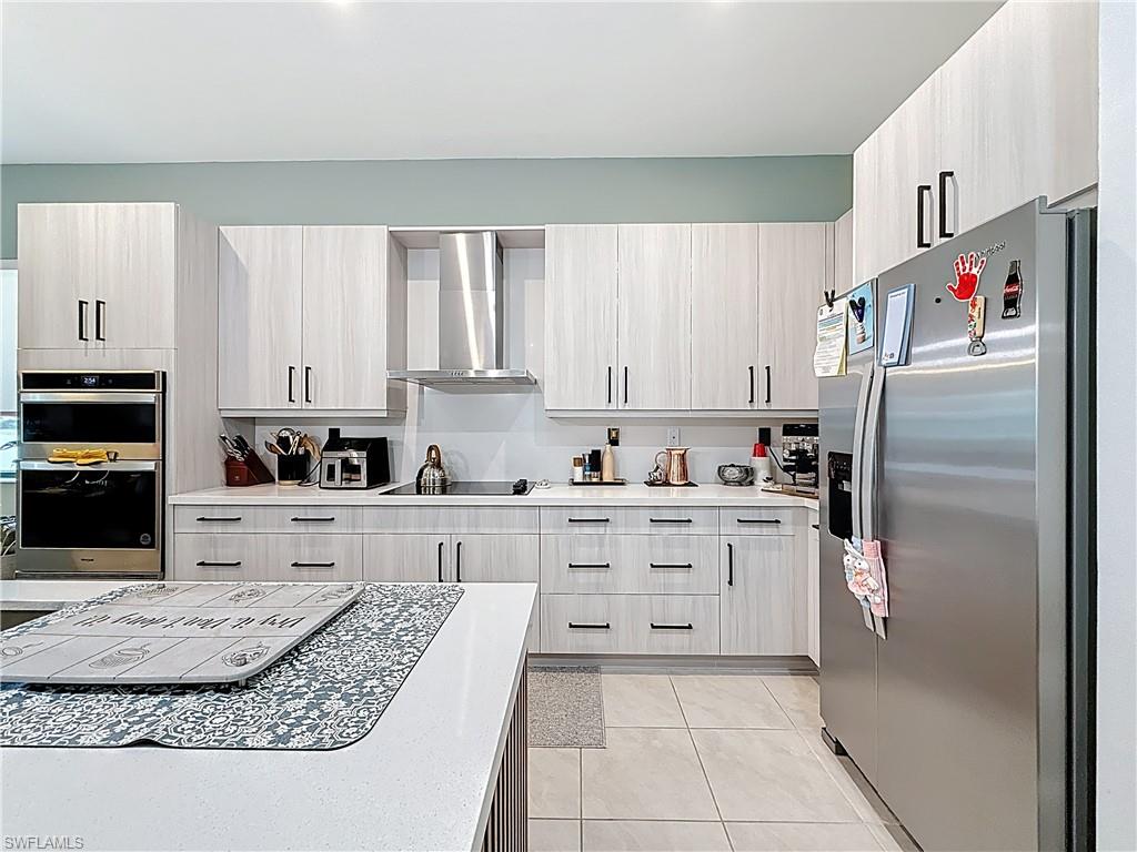 5277 Lamone Ln Avenue Immokalee, FL 34142 - Photo 5 of 27 a kitchen with stainless steel appliances granite countertop a refrigerator sink and cabinets