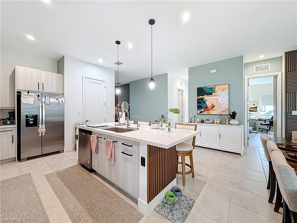 5277 Lamone Ln Avenue Immokalee, FL 34142 - Photo 7 of 27 a kitchen with a sink and refrigerator