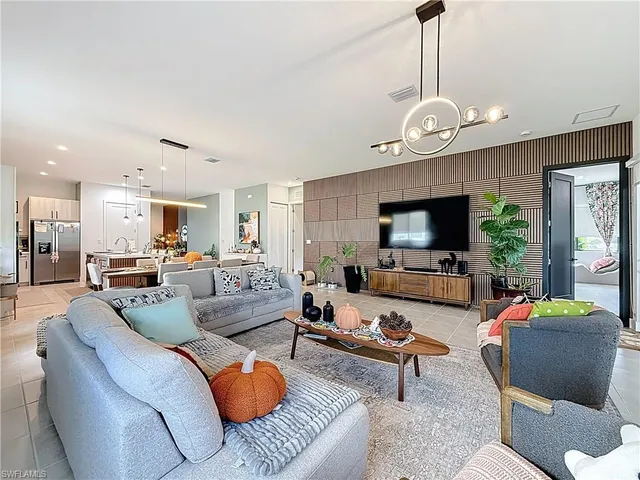 a living room with lots of furniture and kitchen view