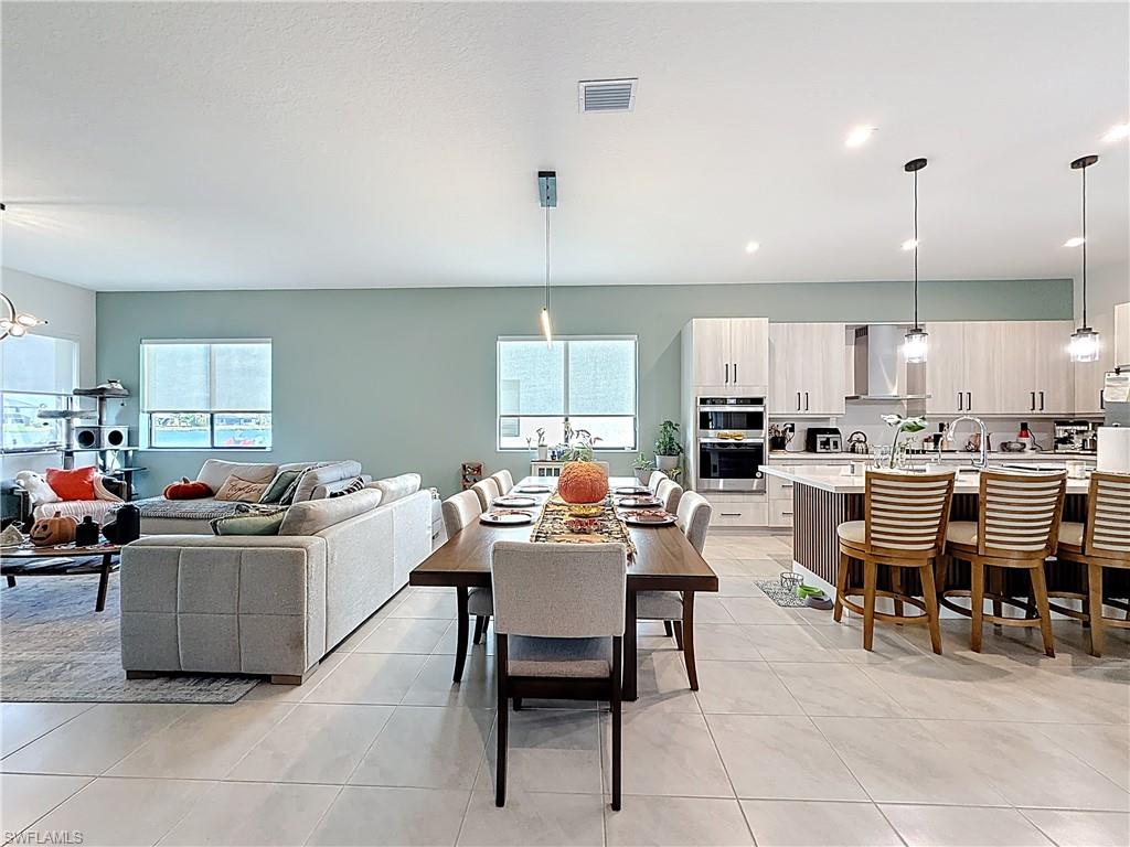 5277 Lamone Ln Avenue Immokalee, FL 34142 - Photo 9 of 27 a living room with lots of furniture and kitchen view