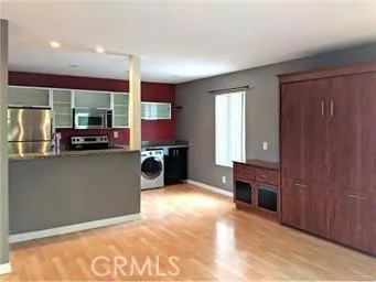 a view of a kitchen with stainless steel appliances granite countertop a stove top oven
