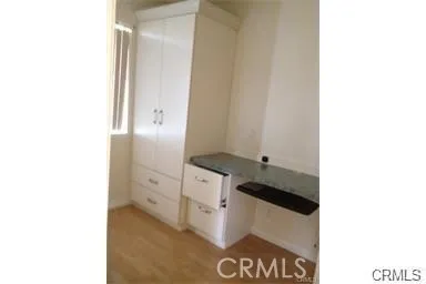 a bathroom with a granite countertop sink a mirror and a shower