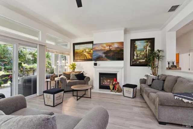 a living room with furniture fireplace and a flat screen tv