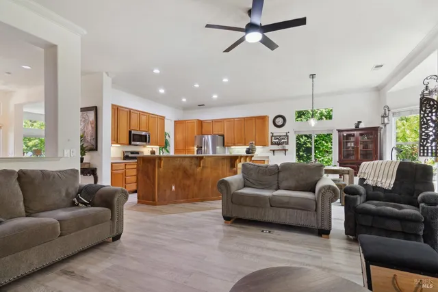 a kitchen with wooden cabinets sink and stainless steel appliances