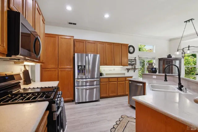 a kitchen with a sink stove and wooden cabinets