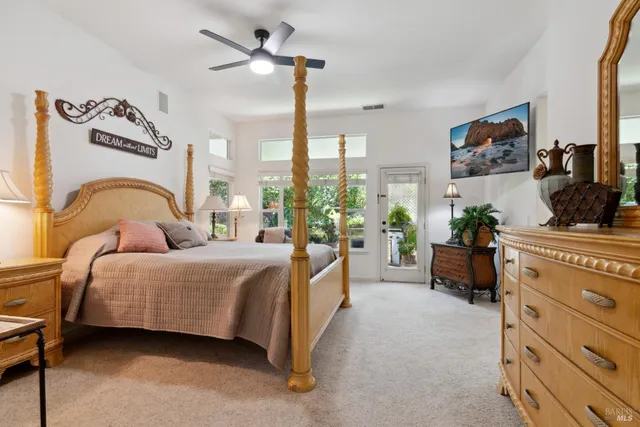 a bedroom with a bed a large window with the outer view