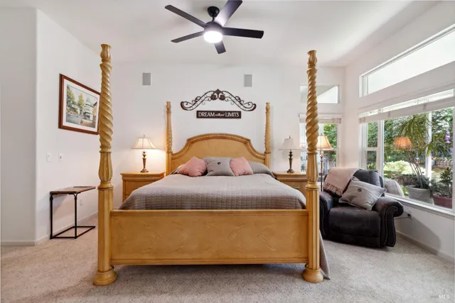 a spacious bathroom with a double vanity sink a mirror a window and a shower