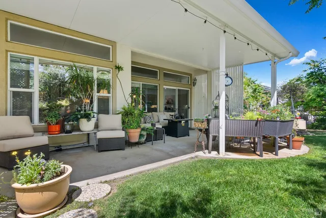 a view of a chair and tables in the garden