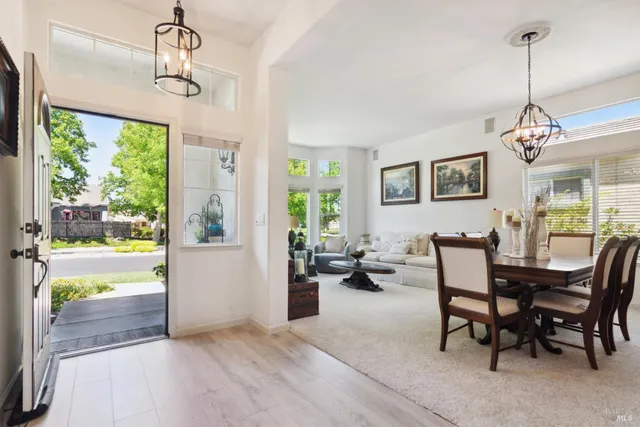 a view of a a dining room with furniture window and wooden floor