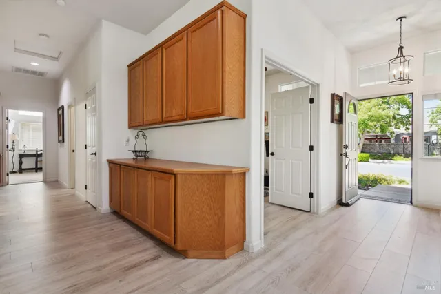 a dining room with furniture a chandelier and a window