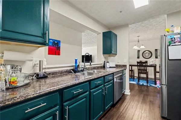 a kitchen with stainless steel appliances granite countertop a sink stove and cabinets