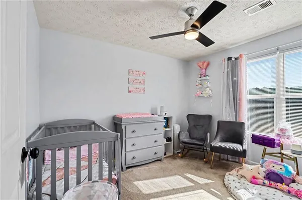 a bedroom with furniture and a window