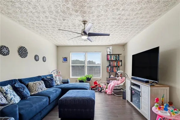 a living room with furniture and a flat screen tv