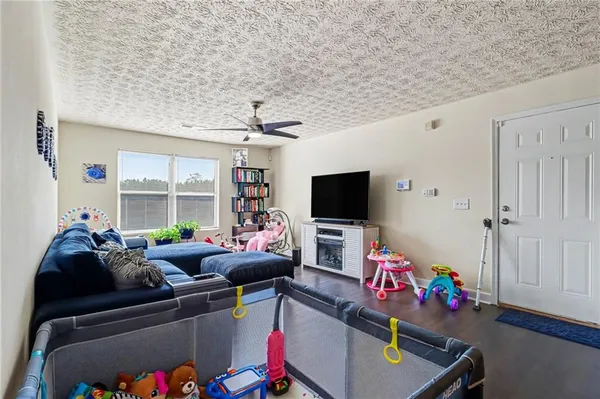 a living room with furniture and a flat screen tv