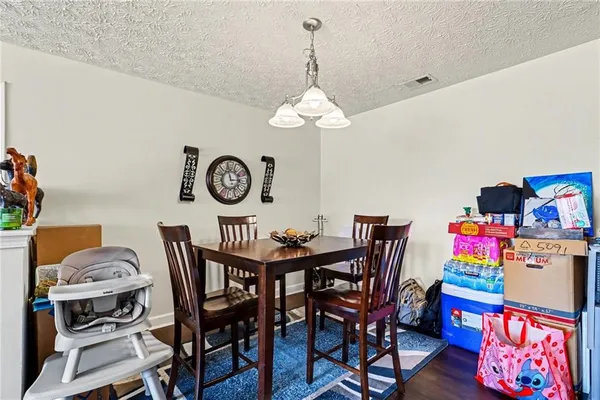 a dining room with furniture and a chandelier