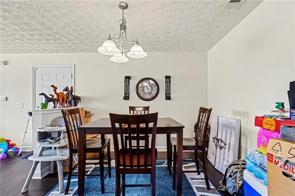 a view of a dining room with furniture and chandelier